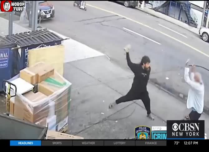 Video :A homeless man uses a brick to strike another man